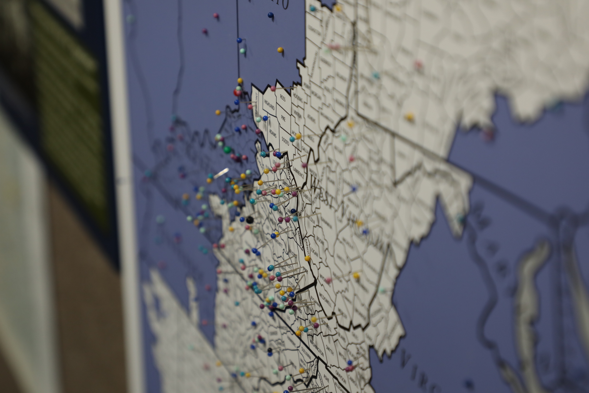 A color photo of a map of Appalachia with many pins denoting places people are from.
